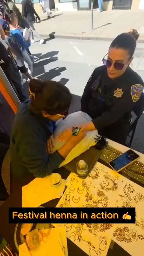 Jahnavi applying henna at her booth at the SF Autumn Moon Festival